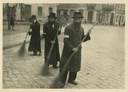62 63. Three Photographs from the Holocaust Period 1. Jews wrapped in a prayer shawls and Tefillin, out in the street, with two Gestapo soldiers standing next to them.