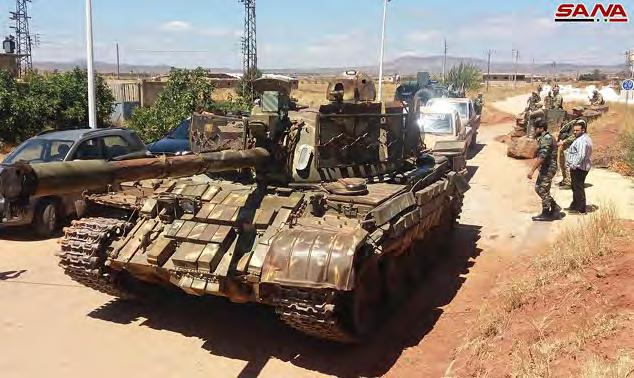 מימין : טנק של כוחות המורדים, שנמסר לצבא סוריה בעיירה ג' באתא אלח' שב. משמאל : משגר רקטות רב- קני של כוחות המורדים, שנמסר לצבא סוריה ) סאנא, 28 ביולי ( 2018.