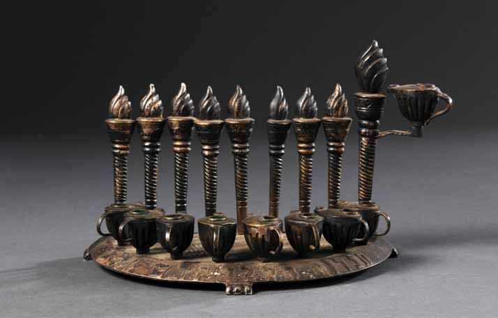 146. Silver Chanukah Lamp Bezalel Chanukah lamp, product of Bezalel Jerusalem. Early 20th century. Silver (unstamped), embossed and curved.