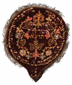 In the center is embroidered in Hebrew the name of the owner David ben Asher Zlk, 1911, and around, the blessing for eating matzo. The inscription has discrepancies in some of the words.