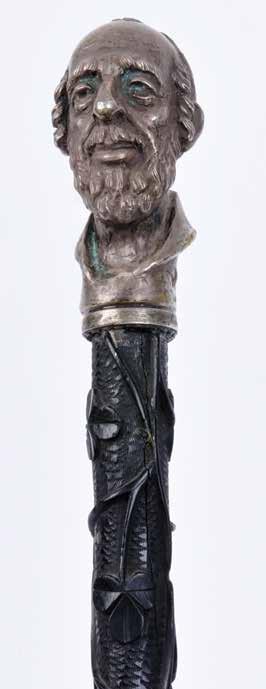 The handle, made of silver, is designed in the shape of a Jew s head, wearing a Kippah, with side curls and a beard. The head is bald.