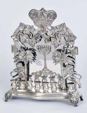 129. Hanukkah Lamp Poland, end of 19 th Century Hanukkah lamp. Warsaw, Poland, end of 19 th century. Silver plated copper. The lamp has a cast base with legs, upon which are small cups.