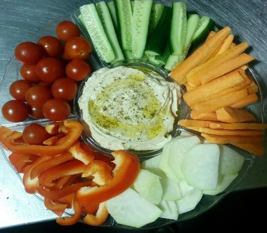 Vegetable platter Selection of vegetable sticks, cherry tomatoes and baby corn centered with a
